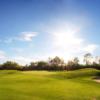 A sunny day view of a green at Pipestone Golf Club.