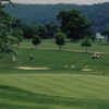 A view of green with narrow path and water in background at Fairway River Links