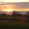 A sunset view of the driving range at Prairie Trace Golf Course