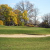 A view of a green protected by a bunker at Stone Ridge Golf Club