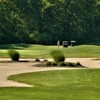 A view of a green protected by a bunker at Robin's Nest Golf Course