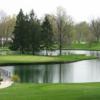 A view of a green surrounded by water at Twin Lakes Golf Course