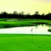 A view of green with water in background at Heatherwoode Golf Club