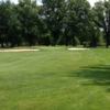 A view of a green flanked by bunkers at Madison Country Club