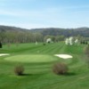 A spring day view of a hole protected by sand traps at Fairway's Riverside Golf Course