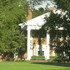 A view of the clubhouse with green in foreground at Columbus Country Club