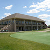 A view of the clubhouse with putting green in foreground at Little Bear Golf Club