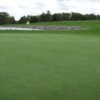 A view of the 18th green with water in background at Crown Hill Golf Club